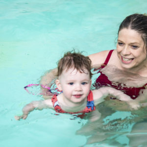 parent with child swimming