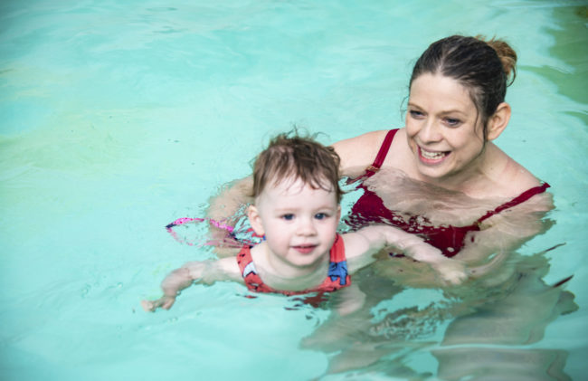 parent with child swimming