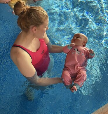 child swimming with parent