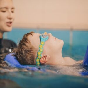 child being taught how to swim