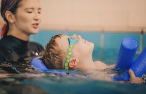 child being taught how to swim