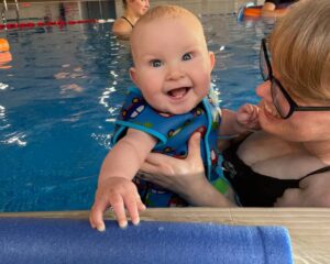 baby and the mother in the pool